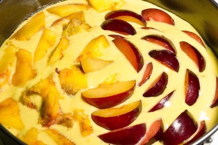 A fresh flour with peaches and plums before bakingの写真素材