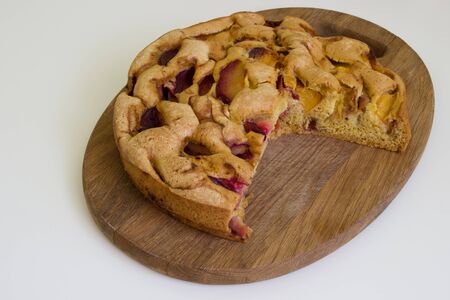 Finished pie of plumes and peaches on the wood desk and white backgroundの写真素材