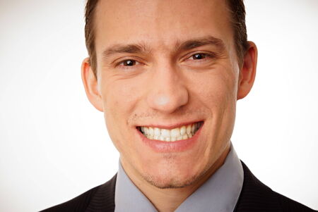 Portrait of a smiling young businessman at suit close up