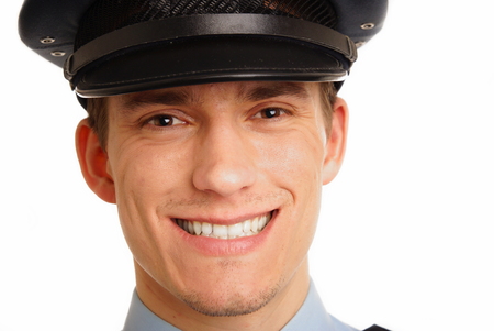 Portrait of smiling young policeman close up 