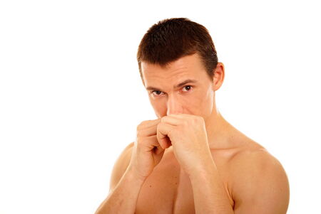 Young athletic man boxes with fistの写真素材