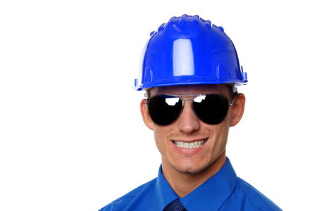 Portrait of young businessman at blue shirt and tie in a helmet 