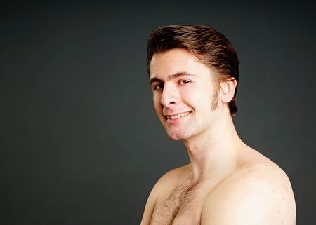 Portrait of young man on grey background, left you can write some textの写真素材