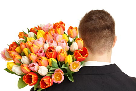 Bouquet tulips on shoulder of young man at suitの写真素材