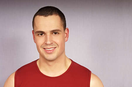 Portrait of young man in red undershirt, right you can write some textの写真素材