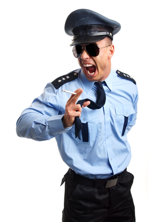 Angry policeman smoking cigarette on white backgroundの写真素材
