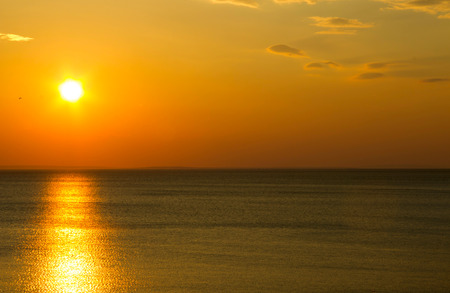 Afterglow of the setting sun shining above sea levelの写真素材