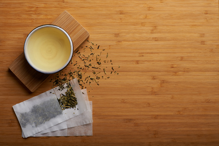 Japanese kukicha tea spilled outside teabag and boiled tea in cup.の写真素材