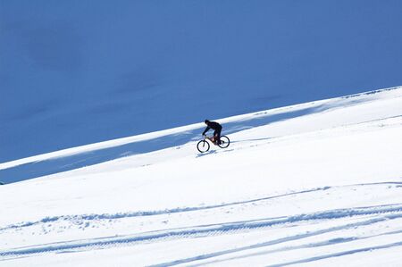 Snow downhill on bikeの写真素材