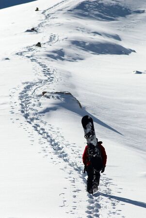 Snowboarder uphill for freerideの写真素材