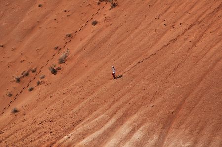 Girl comes down in red loam canyonの写真素材