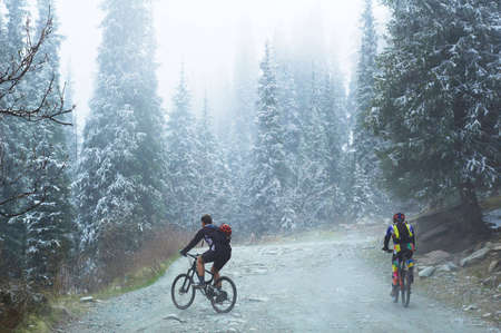 Two bikers in spring mountainsの写真素材