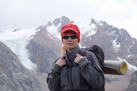 Woman with backpack in high mountainの写真素材