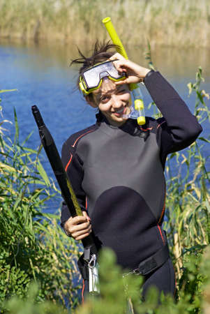Underwater diver girl in lakeの写真素材