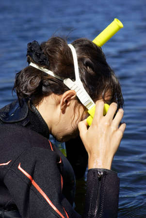 Underwater diver girl in lakeの写真素材