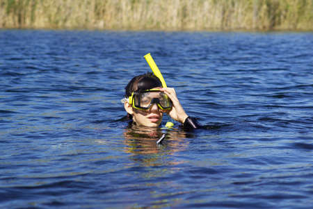 Underwater diver girl in lakeの写真素材