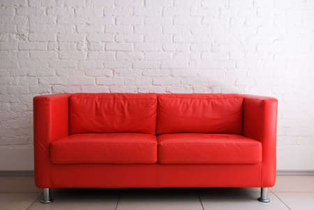 Red sofa and white brick wall