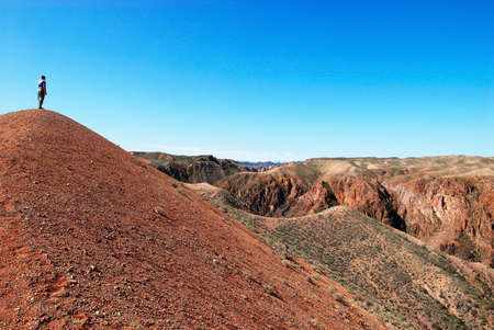 Man walking in desert canyonの写真素材