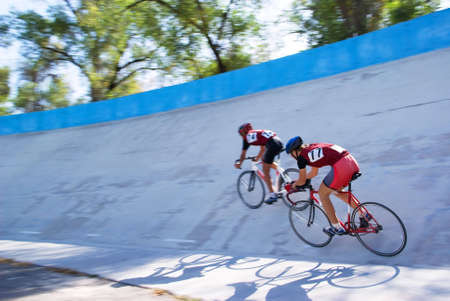 Two cyclist fast racing on velodrome