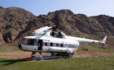 Crashed helicopter in desert mountainsの写真素材