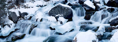 Cascades on a mountain river in winter. Panorama from 6 vertical shotsの写真素材