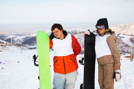 Snowboard couple on mountain ski resortの写真素材