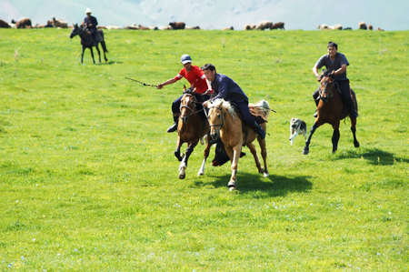 BISHKEK, KYRGYZSTAN - MAY 14: A traditional nomad game of Kokpar in action on May 14, 2006 in Kishkek, Kyrgystan. Kokpar is played on horseback to carry dead goat carcass into a goal.のeditorial素材