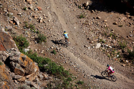 ALMATY, KAZAKHSTAN - SEPTEMBER 13: Kirill Kazantcev (first) and Evgeny Kazantcev  in action at Adventure mountain bike cross-country marathon "Marathon Bartogay-Assy-Batan 2009" September 13, 2009 in Almaty, Kazakhstan.のeditorial素材