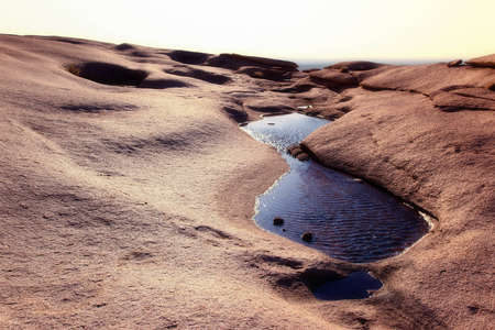 The water in the desert mountains and sun glareの写真素材