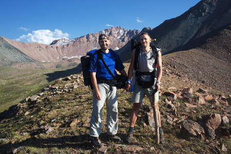 Two backpackers in the summer mountain