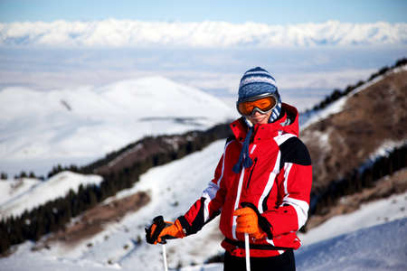 Woman in red on the ski slopesの写真素材
