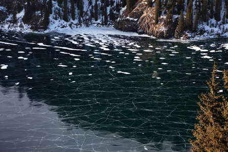 Frozen middle Kolsay lake in Tien-Shan mountains, Kazkahstanの写真素材