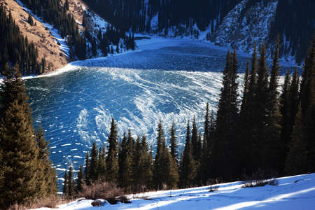 Frozen middle Kolsay lake in Tien-Shan mountains, Kazkahstanの写真素材