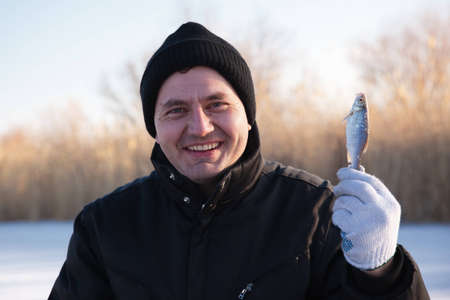 Ice fisherman with small fish