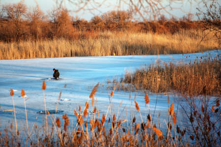 Winter fishing at sunsetの写真素材
