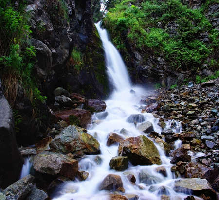 First waterfall in gorge Ayu-Say and flow of water on stoneの写真素材