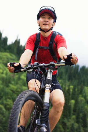Asian mountain biker in summer mountain