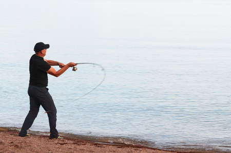 Fisherman throws the fishing rod