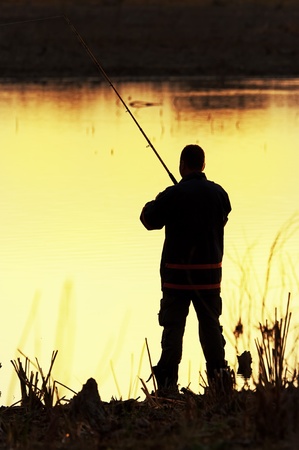 Fisherman silhouette at sunriseの写真素材