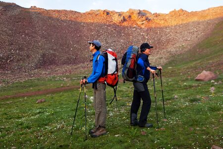 Two backpackers in morning mountains