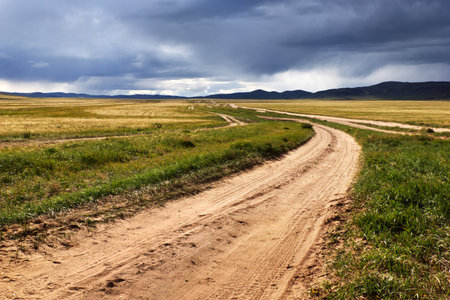 Roads in the desert steppes of Mongolia and the storm skyの写真素材