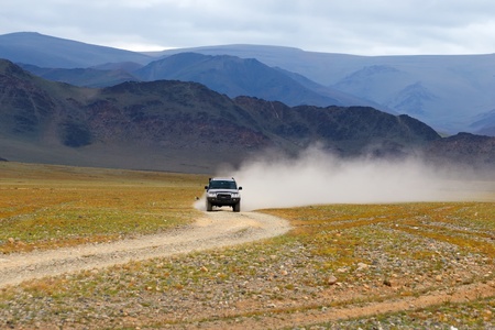 Car on road in the desert mountain of the Mongoliaの写真素材