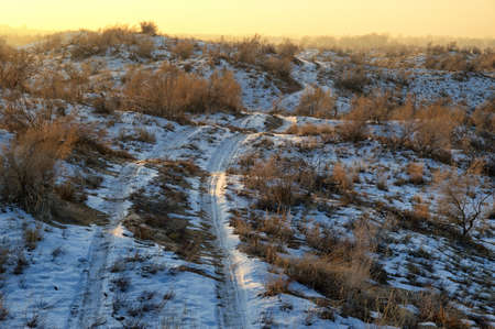 Winter desert and old rural road in Almaty region, Kazakhstanの写真素材
