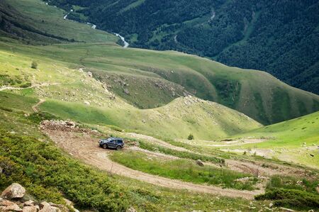 ALMATY REGION, KAZAKSTAN - JULE 08, 2014: Jeep climb from the Kora gorge in Dzungarian Alatau on a dangerous dirt road.のeditorial素材