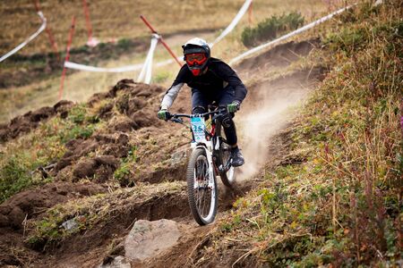 ALMATY, KAZAKHSTAN - AUGUST 22, 2015: L.Gilev (N25) in action at Mountain Bike sports event DOWNHILL EXTREME WEEKEND.のeditorial素材