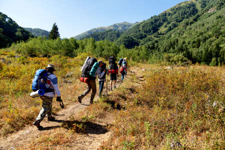 ALMATY REGION, KAZAKHSTAN - AUGUST 07, 2014: People hike to the Zhasylkol lake in Dzungarian Alatau...
