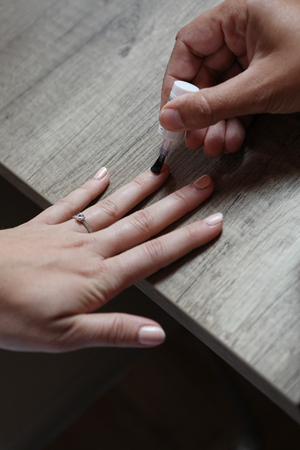 Woman adjusts her nailsの写真素材