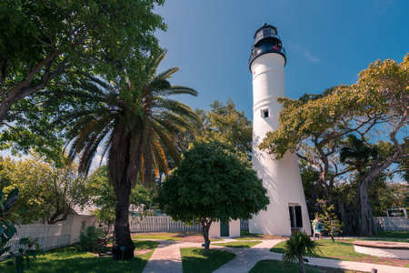 An old lighthouse and its surroundings in the town of Key West, Florida. White buildings on a summer day.の写真素材