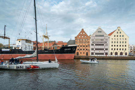 Gdansk, Poland - 05.06.2017: People on a small sport yacht sailing out of a canal in Gdansk, Poland,...