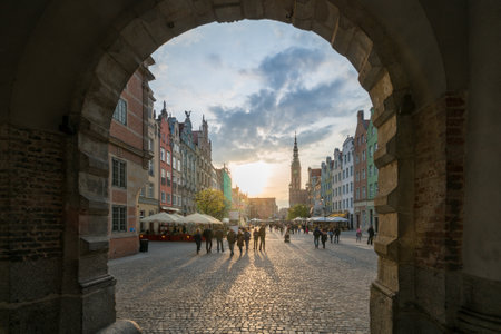 Gdansk, Poland - 05.06.2017: View of an old street with people through arch in historical city....